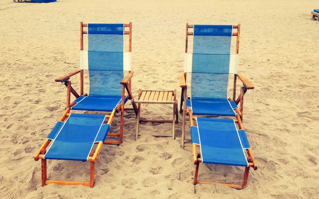 Two chairs on the beach.