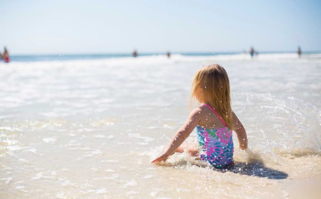 Girl sitting on the beach.