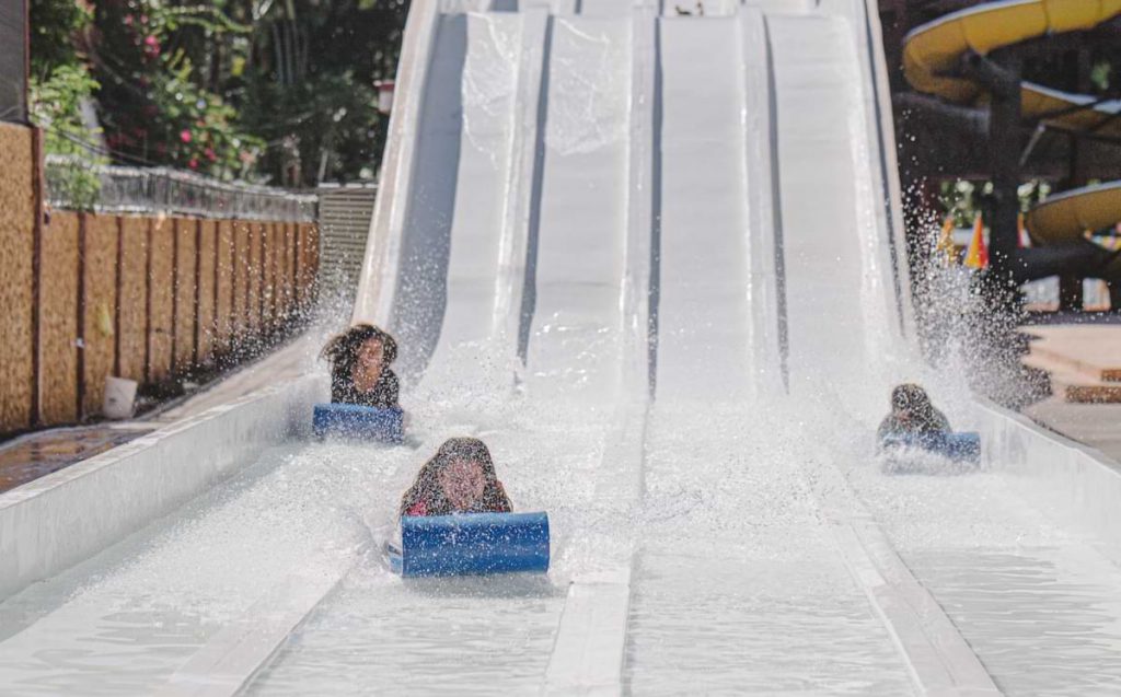 Kids going down a waterslide.